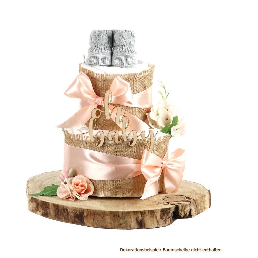 Apricot diaper cake with grey baby booties on a wood slice; note states that the wood slice is not included
