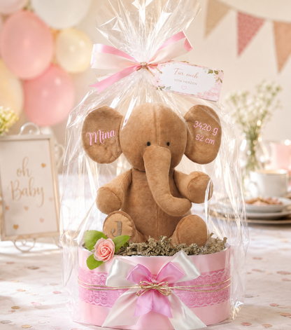 Wrapped pink diaper cake with elephant, personalized with Mina, 3420 g and 52 cm, in a festive setting