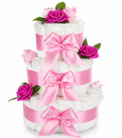 Three-tier pink diaper cake with three satin bows, bright roses and baby socks against a white background