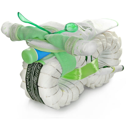 Green diaper motorcycle made from rolled diapers, socks, bibs, a baby bottle and two baby spoons