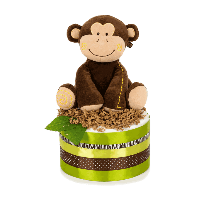 Freigestellte grüne Windeltorte mit brauner Affen-Spieluhr, Papiergras, Blättern und Zierbändern